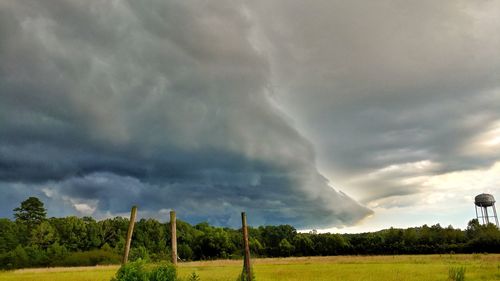 Scenic view of storm clouds over field