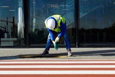 Full length of worker working at railroad station