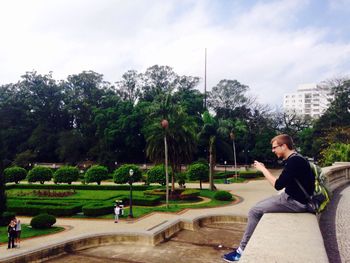 Rear view of woman sitting in park