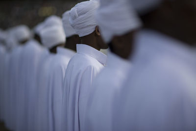 Men wearing traditional clothing standing in row