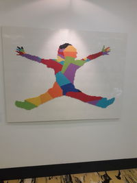 Low angle view of multi colored pencils on wall