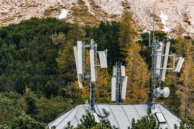 Cluster of mobile network broadcast cell repeaters on roof of a mountain lodge