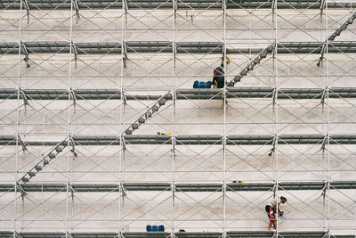 Low angle view of window washer on building