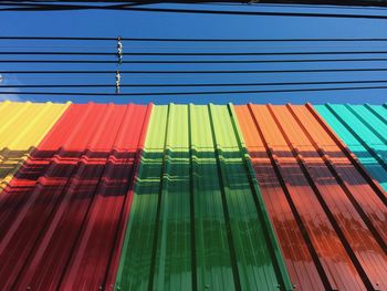 Multi colored umbrella against blue sky