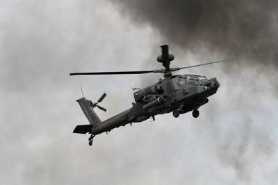 Low angle view of apache helicopter in flying in sky