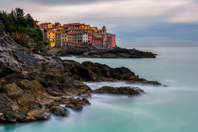 Scenic view of sea and buildings against sky