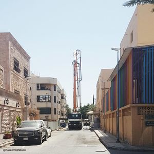 Street amidst buildings against clear sky