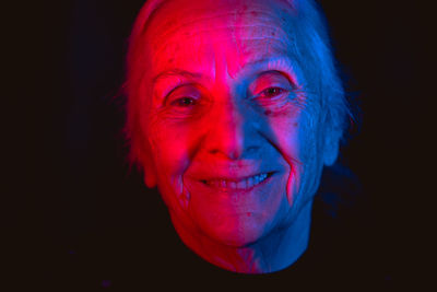 Close-up of young man against black background