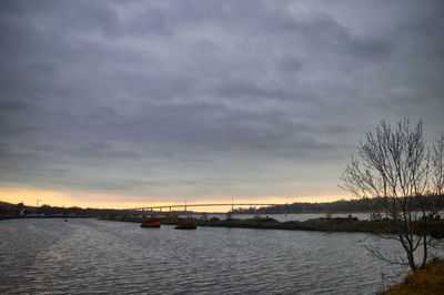 Bridge over sea against sky during sunset