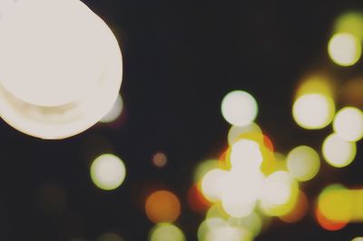 Low angle view of illuminated lights against sky at night