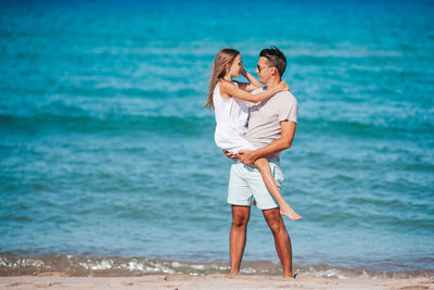 Young couple standing on beach