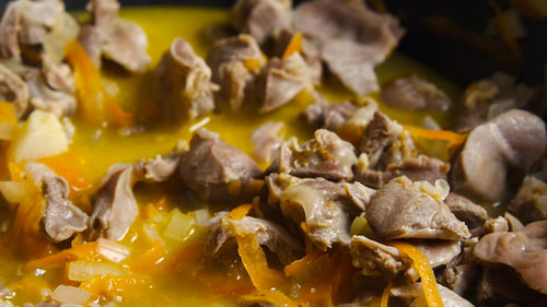 Close-up of chicken gizzard stewing with vegetables in a wok. asian-style cooking