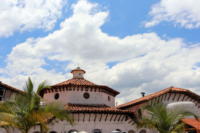 Low angle view of building against cloudy sky