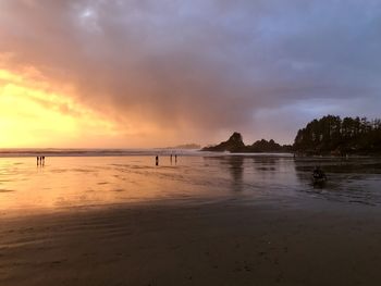 Scenic view of beach against sky during sunset