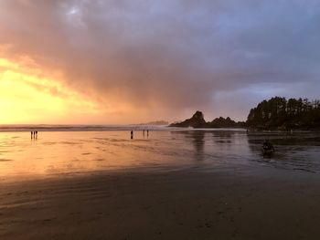 Scenic view of beach against sky during sunset