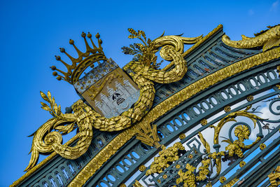 Low angle view of decoration against blue sky