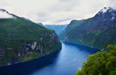 Scenic view of waterfall against sky