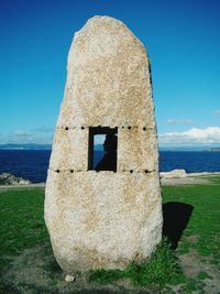 Built structure by sea against sky