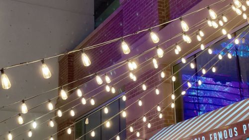 Low angle view of illuminated building against sky at night