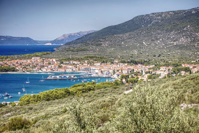 Scenic view of sea and townscape against sky