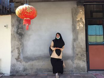 Woman standing against wall