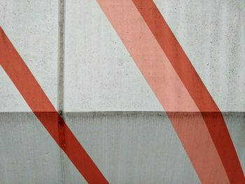 Full frame shot of white wall with red stripes