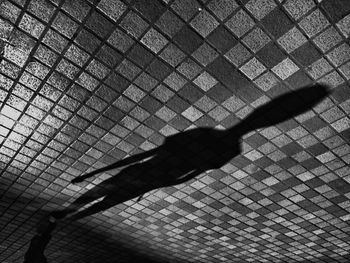 Shadow of person on tiled floor