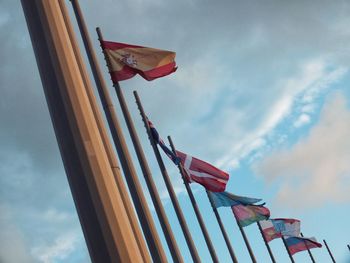 Low angle view of flag flags against sky