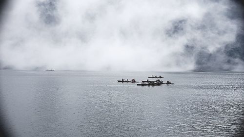 Ship sailing on sea against sky