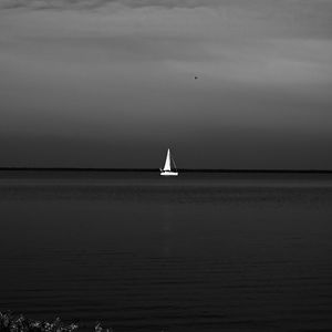 Sailboat sailing on sea against sky at night