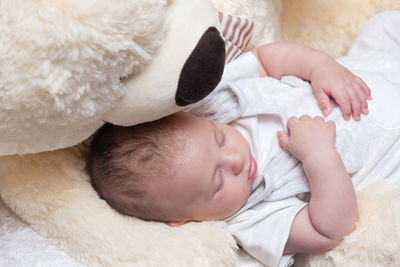 High angle view of baby sleeping on bed