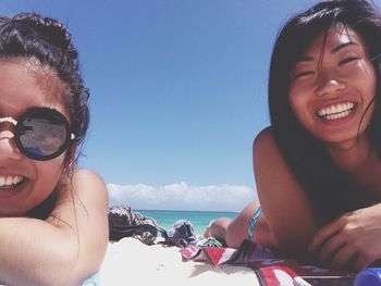 Portrait of young women relaxing on beach during vacation
