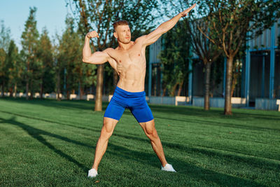 Full length of man exercising on field