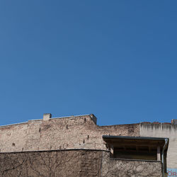 Low angle view of built structure against clear blue sky