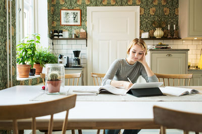 Teenage girl studying at home