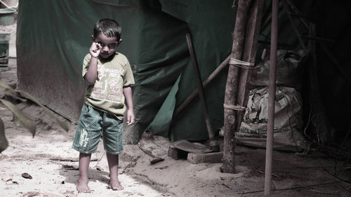 Portrait of boy standing on field