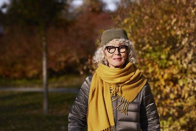 Portrait of senior woman in autumn scenery