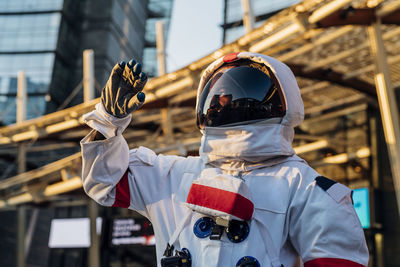 Male astronaut wearing space suit looking away