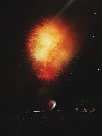 Low angle view of firework display at night