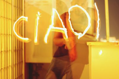 Full length of illuminated woman at night