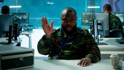 Portrait of young man using mobile phone in cafe