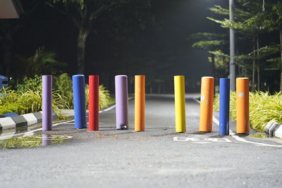 Row of multi colored pencils on road