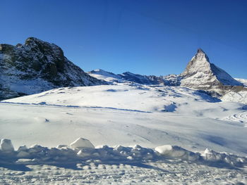 Scenic view of snowcapped mountains against clear sky