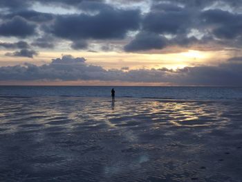 Scenic view of sea against cloudy sky