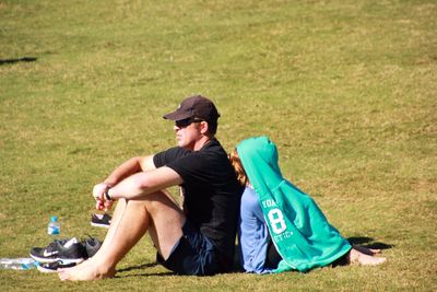 Woman sitting on grassy field