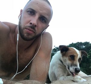 Portrait of young man with dog