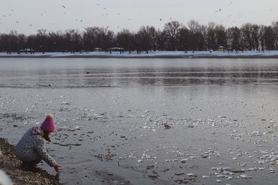 View of dog in lake during winter