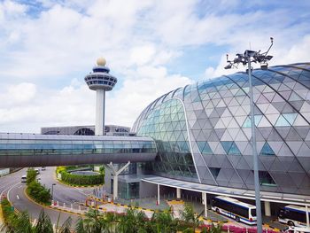 View of modern building against cloudy sky