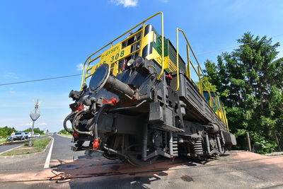 Low angle view of train on road against sky