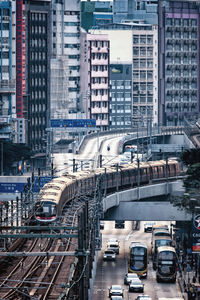 High angle view of traffic on road amidst buildings in city